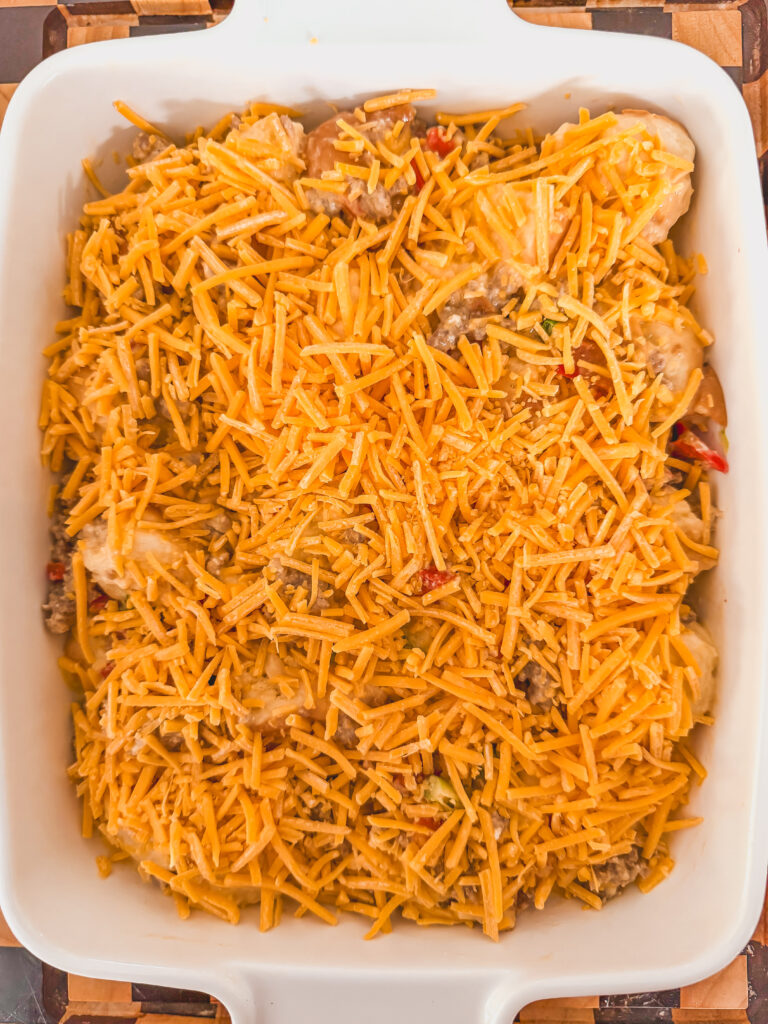 shredded cheddar cheese on top of the kings hawaiian breakfast casserole with sausage.
