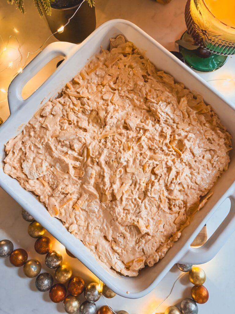 Greek yogurt buffalo chicken dip in a white baking dish.