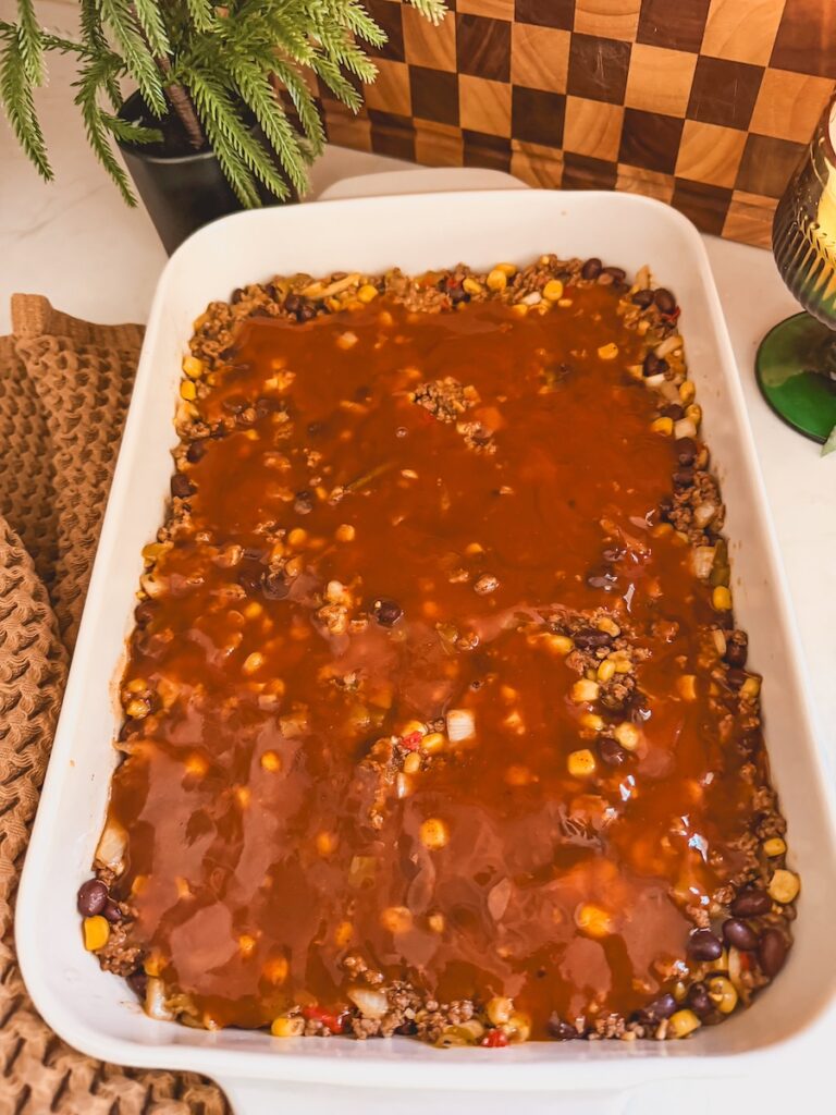 Ground beef, beans, and corn mixture with enchilada sauce on top.