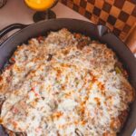 Baked Philly Cheesesteak Casserole in a cast iron skillet.