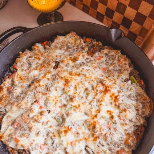 Baked Philly Cheesesteak Casserole in a cast iron skillet.