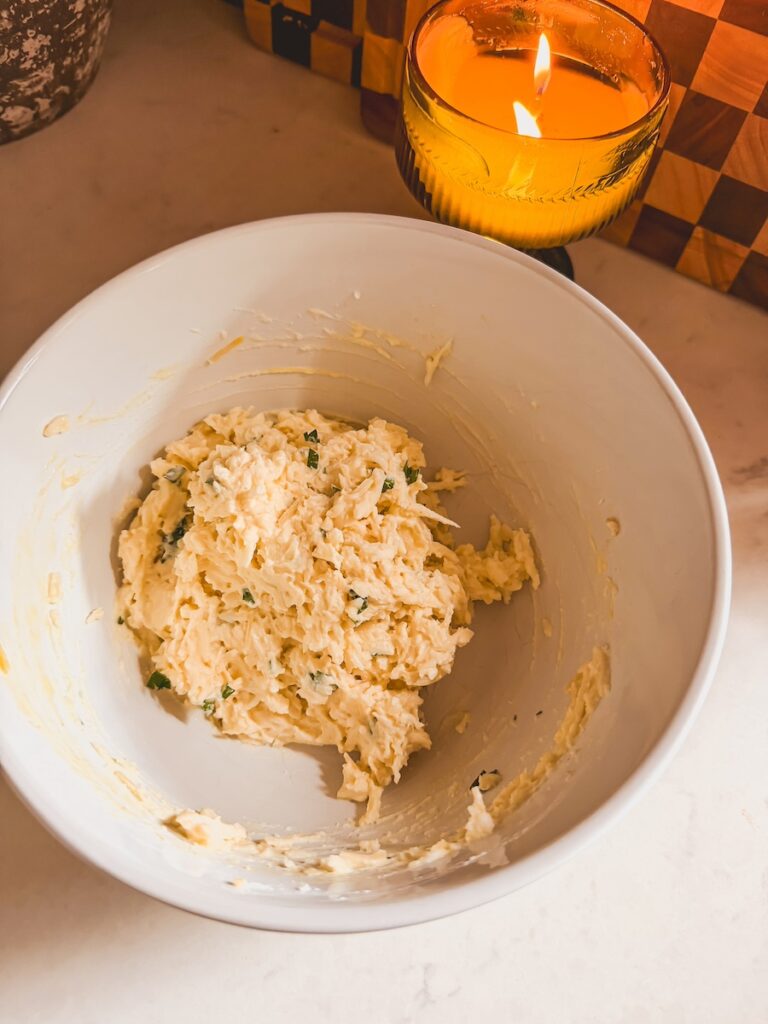 A white bowl with ricotta cheese mixture.