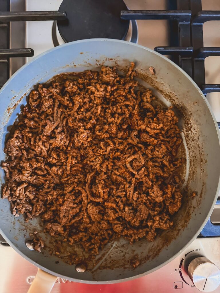 cooking brown meat with taco seasoning