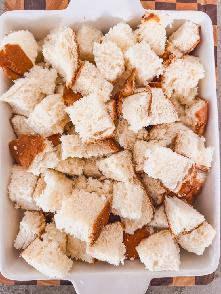 kings hawaiian round bread cut into cubes and put in baking dish