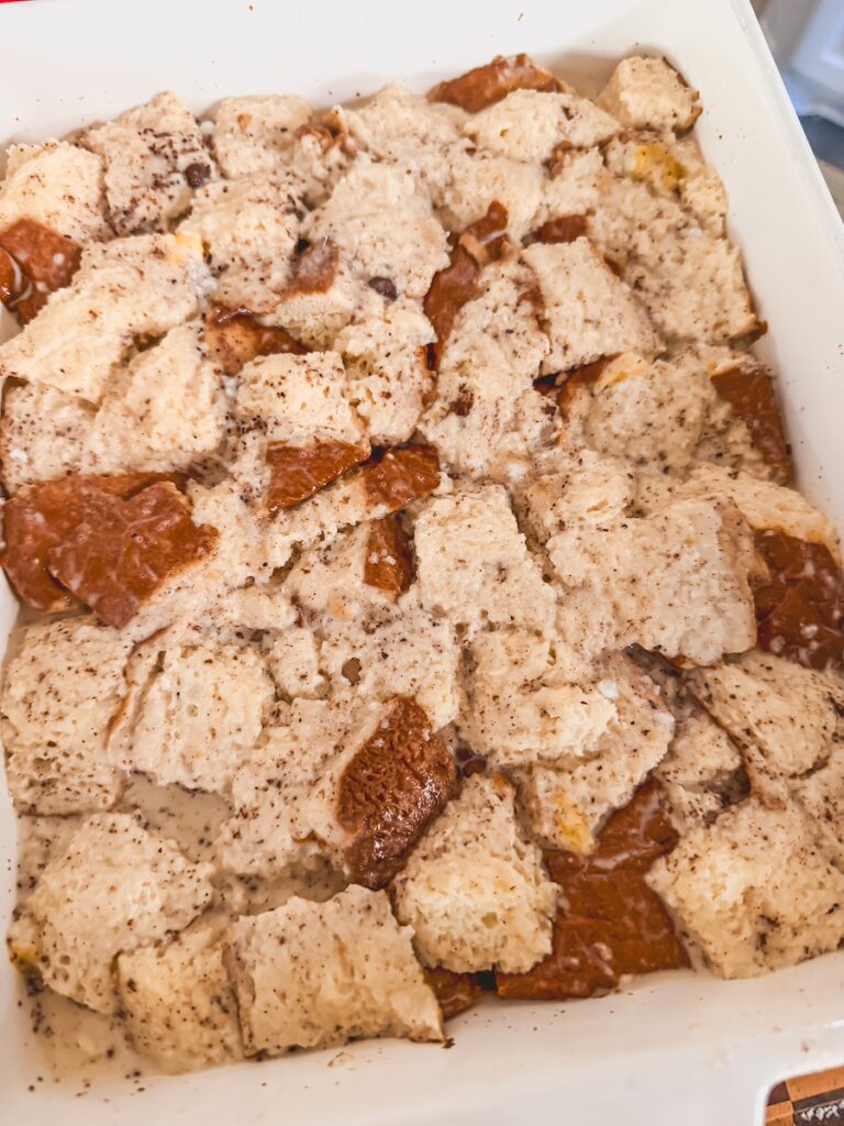 custard poured over bread cubes and pushed down in baking dish