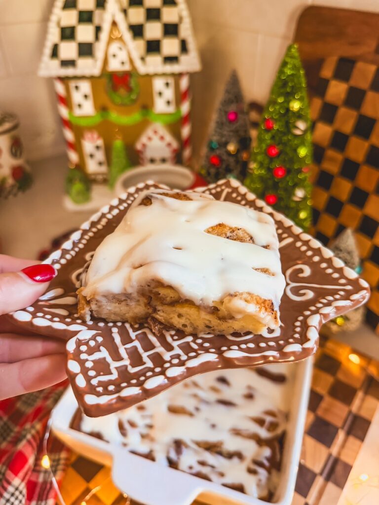 a piece of cinnamon roll bread pudding on a gingerbread plate