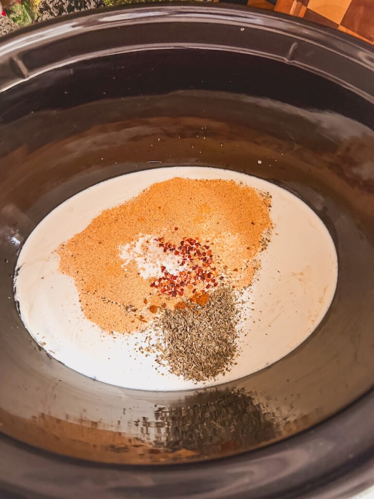 cornstarch and chicken broth with spices in slow cooker