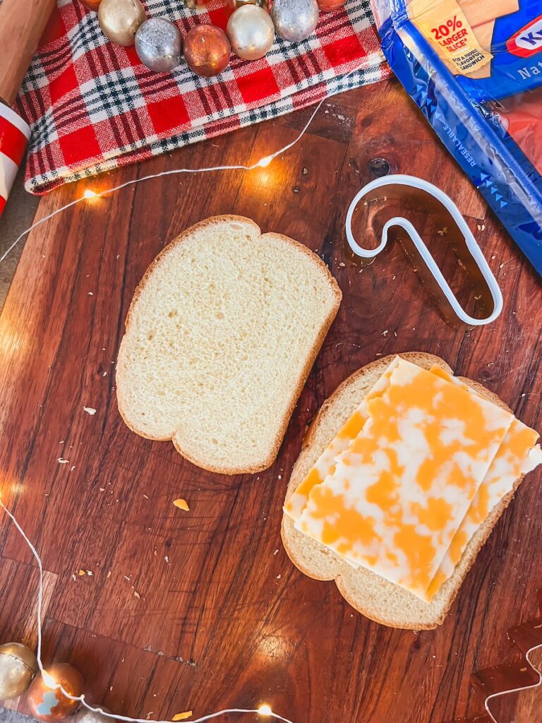 place cheese on bread next to cookie cutter