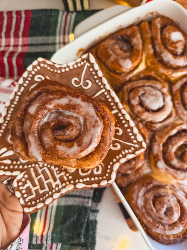 gingerbread cinnamon roll on a gingerbread house plate 