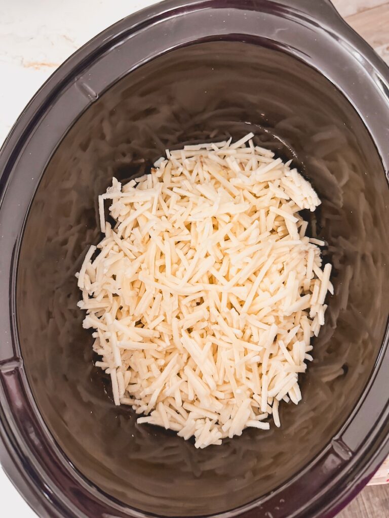uncooked frozen hashbrowns in bottom of slow cooker