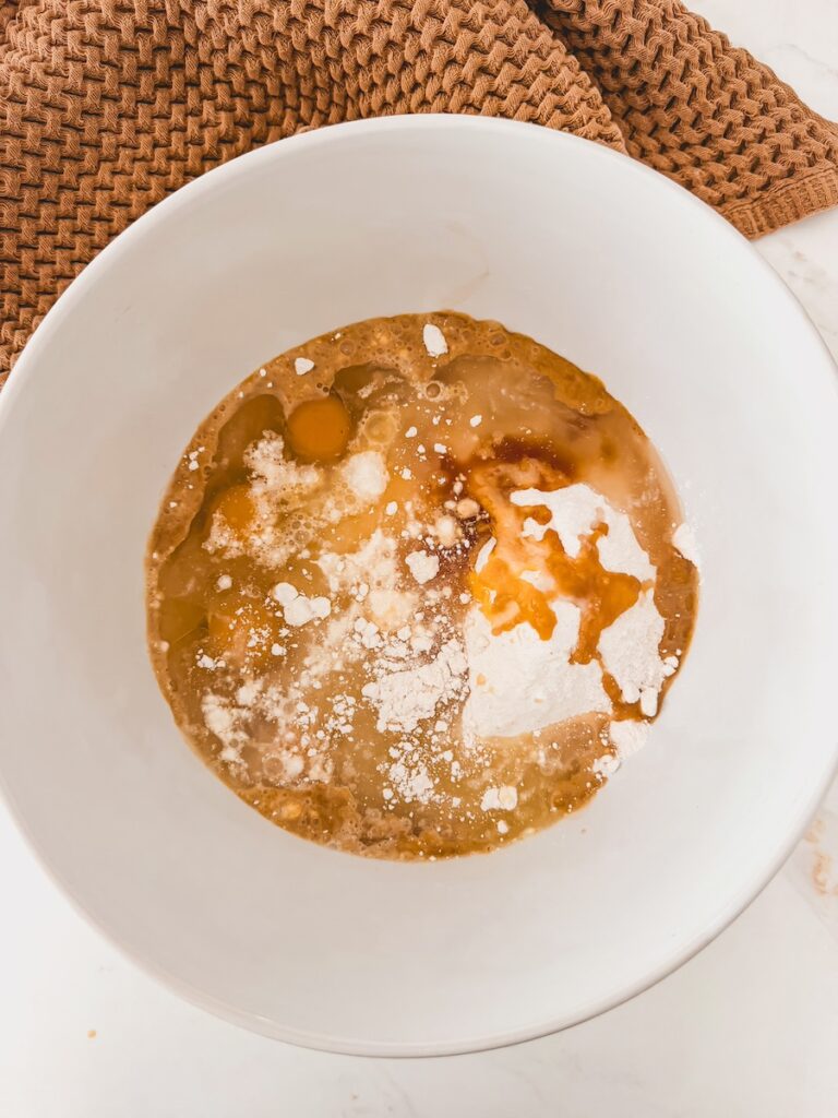 A white bowl with ingredients for the cake base of Baileys Irish cream cake.