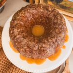 Baileys Irish Cream Bundt Cake on a white cake stand.