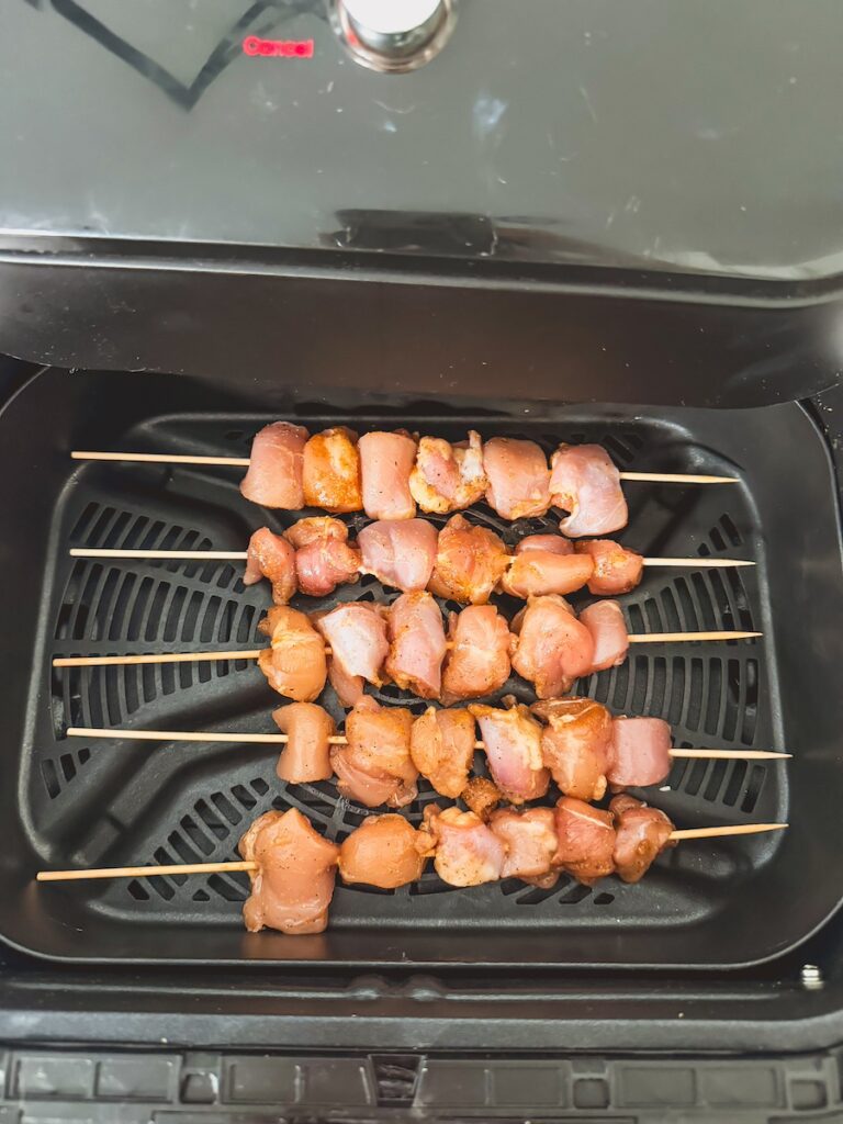 Chicken teriyaki skewers in the air dryer basket ready to cook.