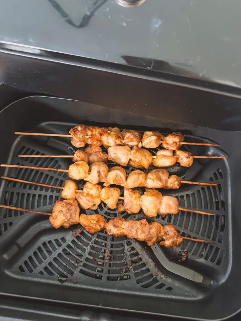 Chicken teriyaki skewers being cooked in the air fryer.