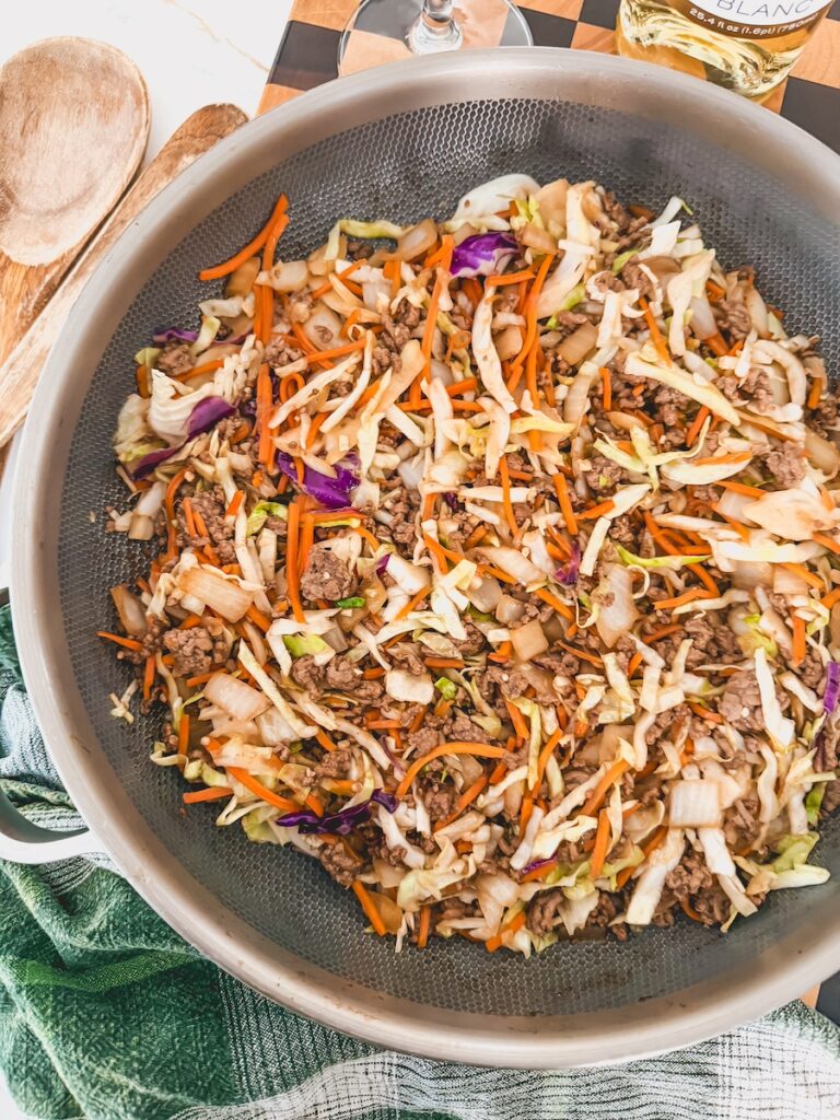 ground beef, onion , cabbage and carrots in skillet