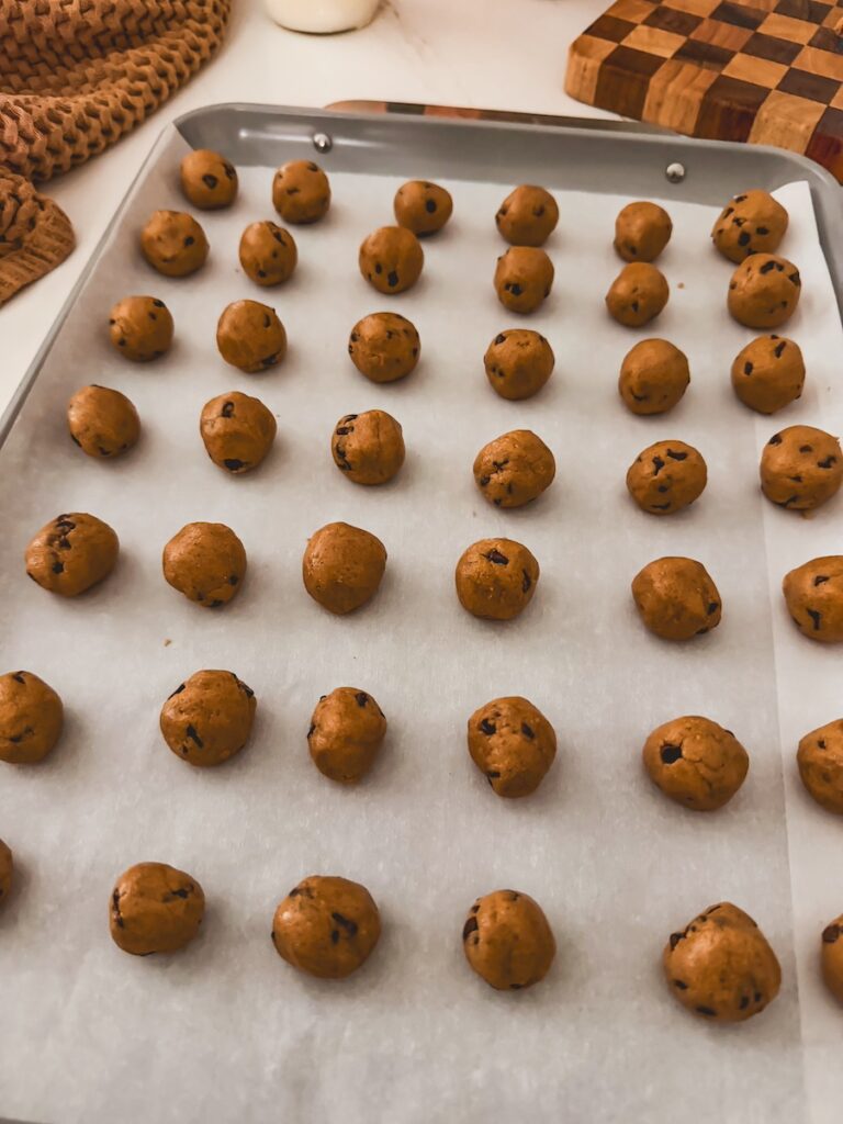 cookie dough balls on a baking sheet
