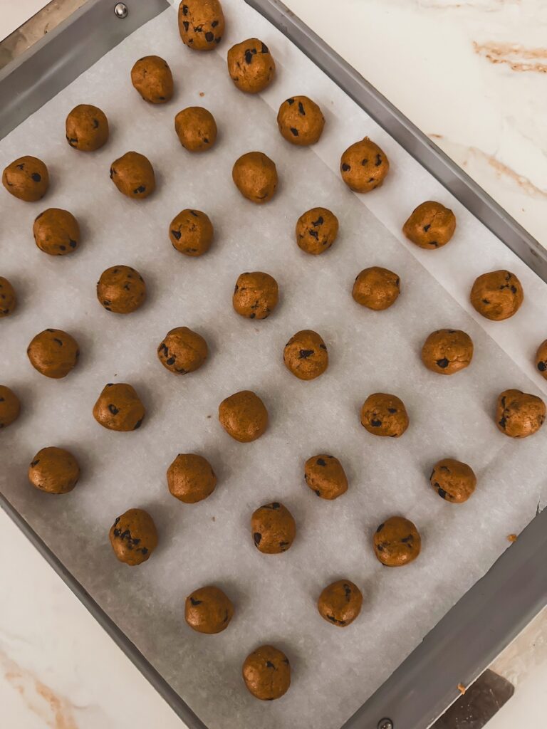 cookie dough balls on a baking sheet