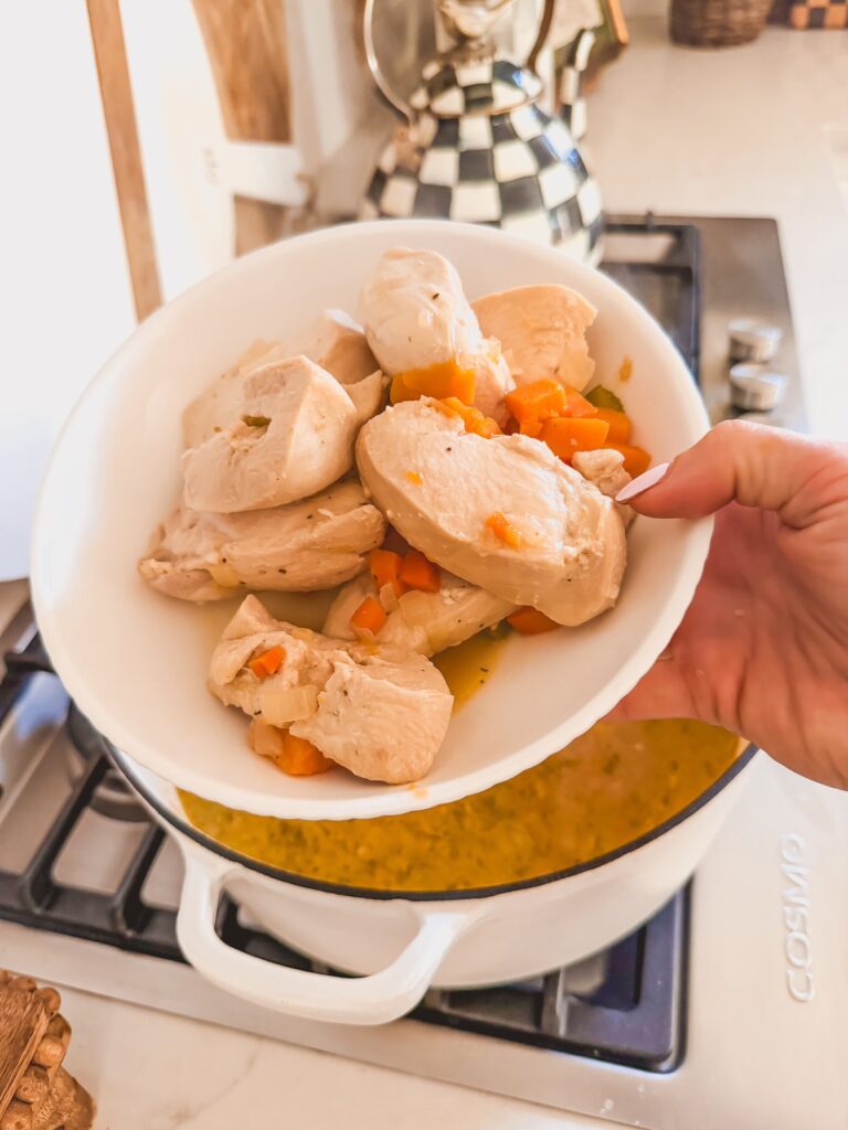 remove chicken and shred , chicken removed in white bowl
