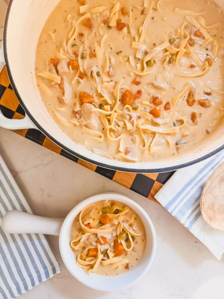 bowl of soup next to dutch oven filled with soup