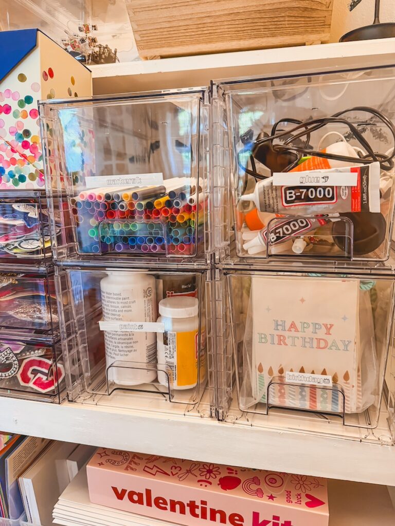 close up shot of clear drawers with paint, glue and supplies