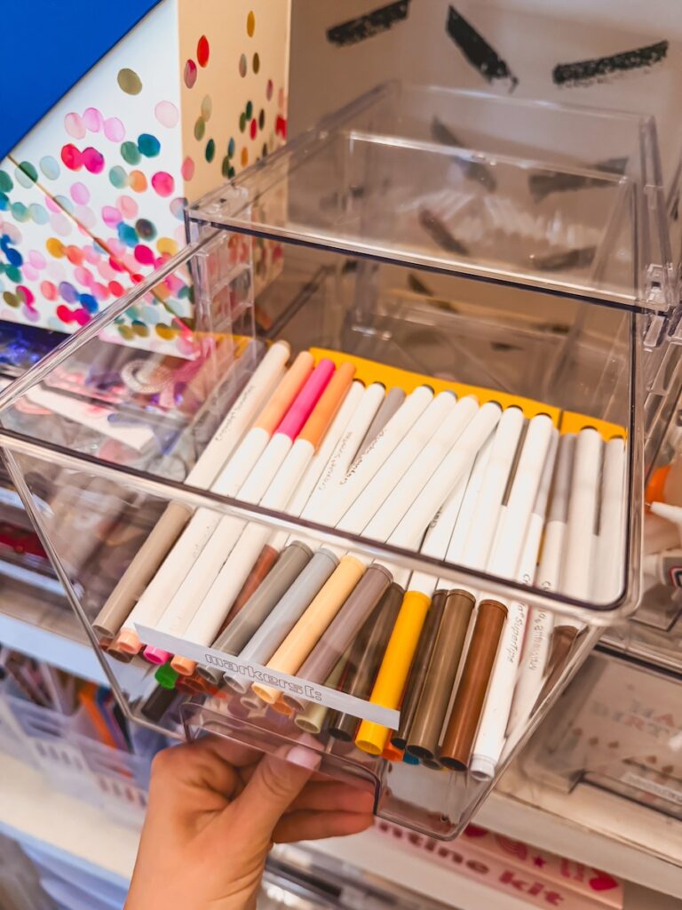 close up of clear bin with markers