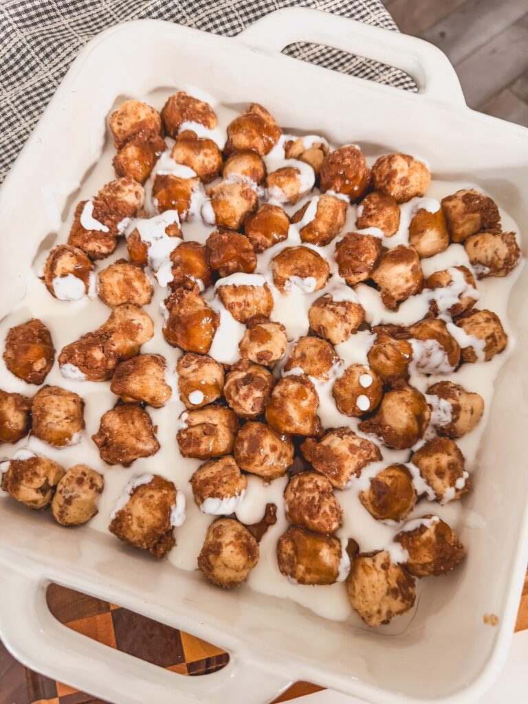 kefir poured in the baking dish with cinnamon roll bites