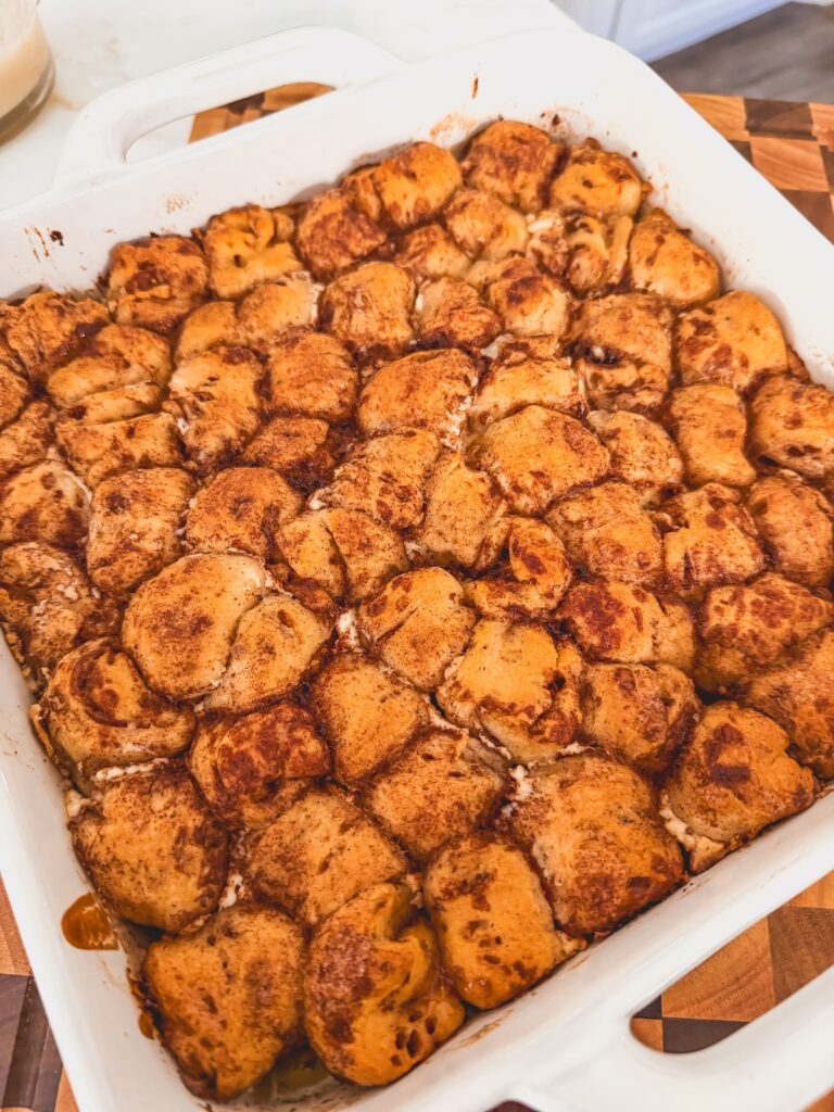 cooked cinnamon roll bites in white baking dish