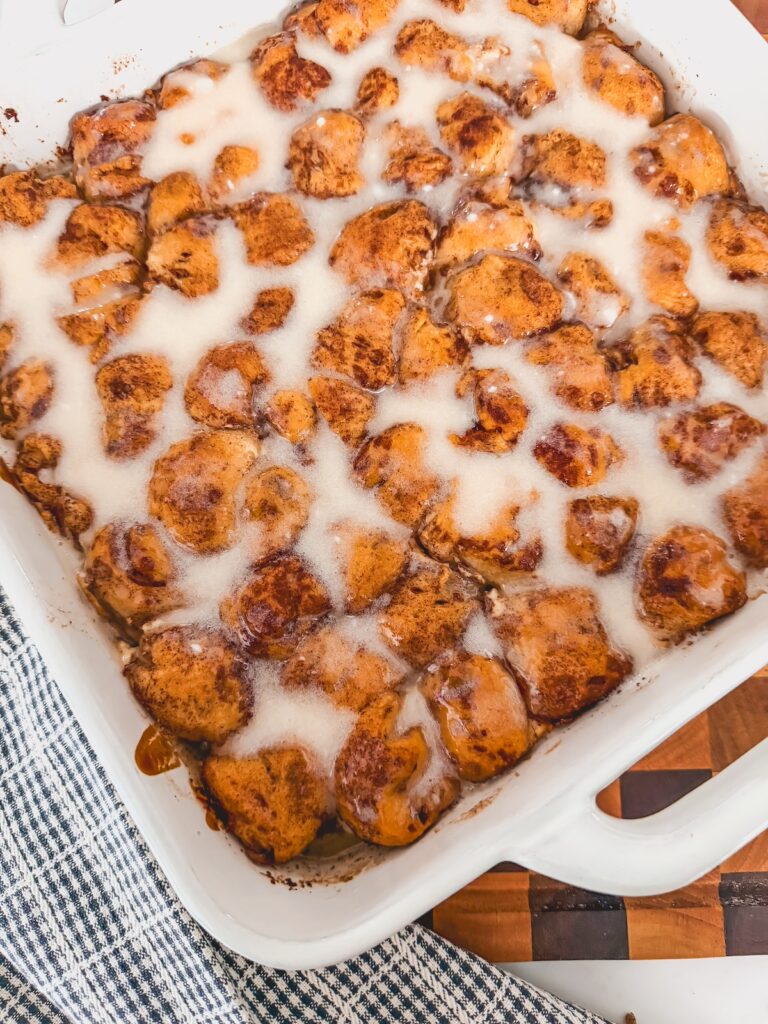 cinnamon roll bites casserole in white baking dish