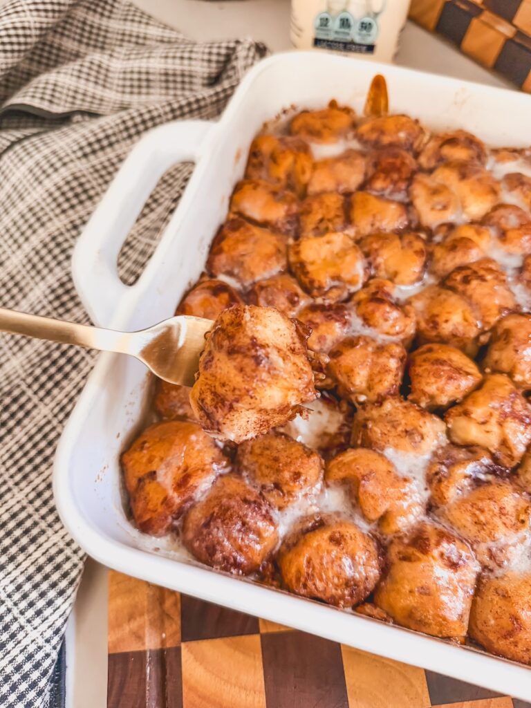 cinnamon roll bite on a fork with cinnamon roll bites