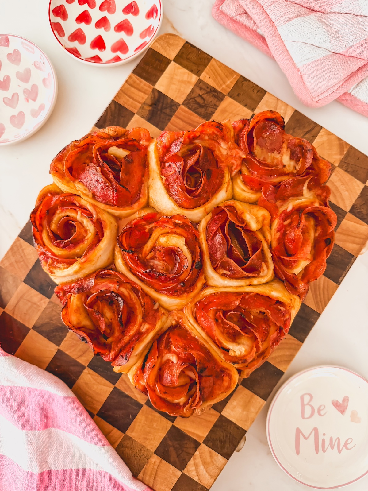 heart shaped pizza roses on a wood board