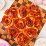 heart shaped pizza rose dish on a wood board