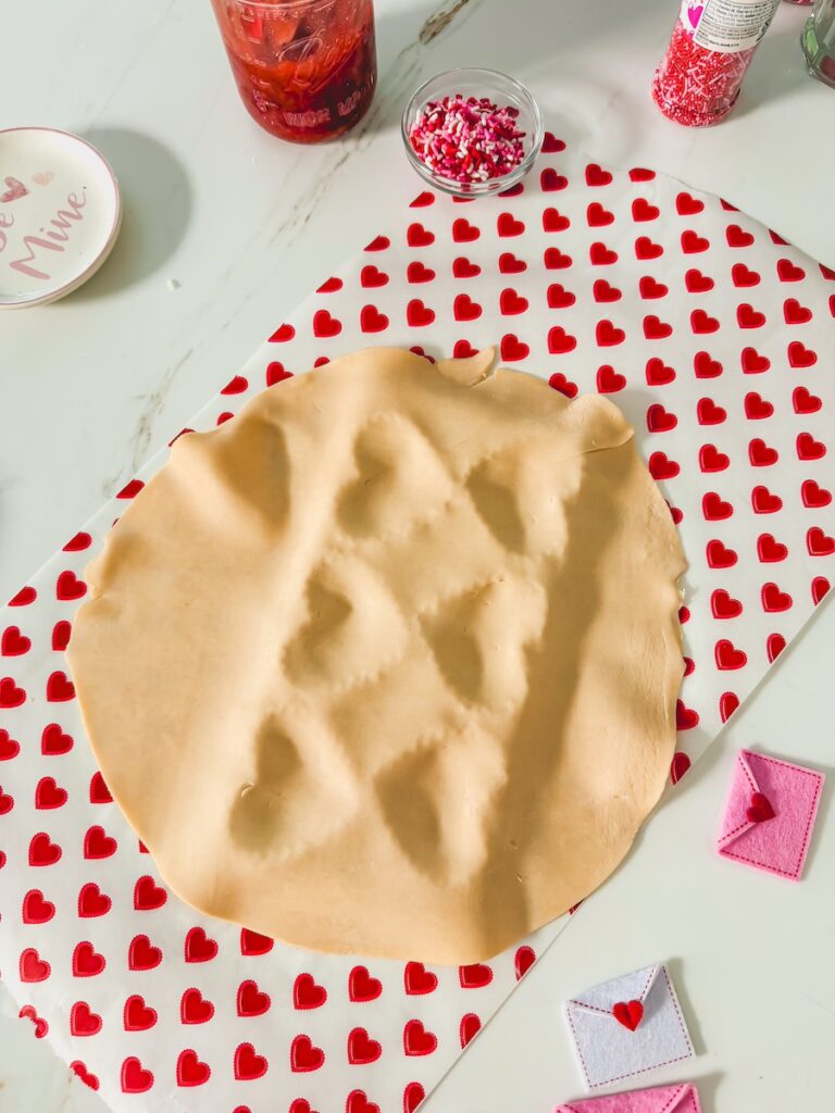 pie crust dough laid on top of ravioli heart mold