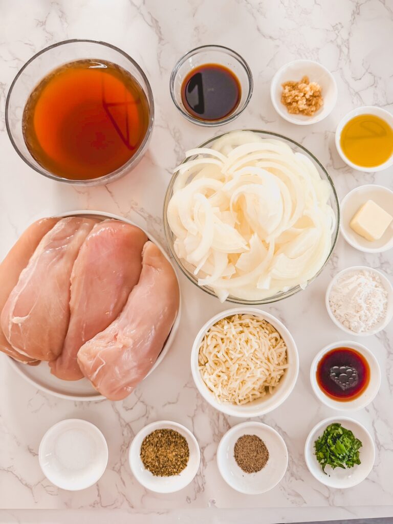 french onion chicken ingredients in bowl on marble background.