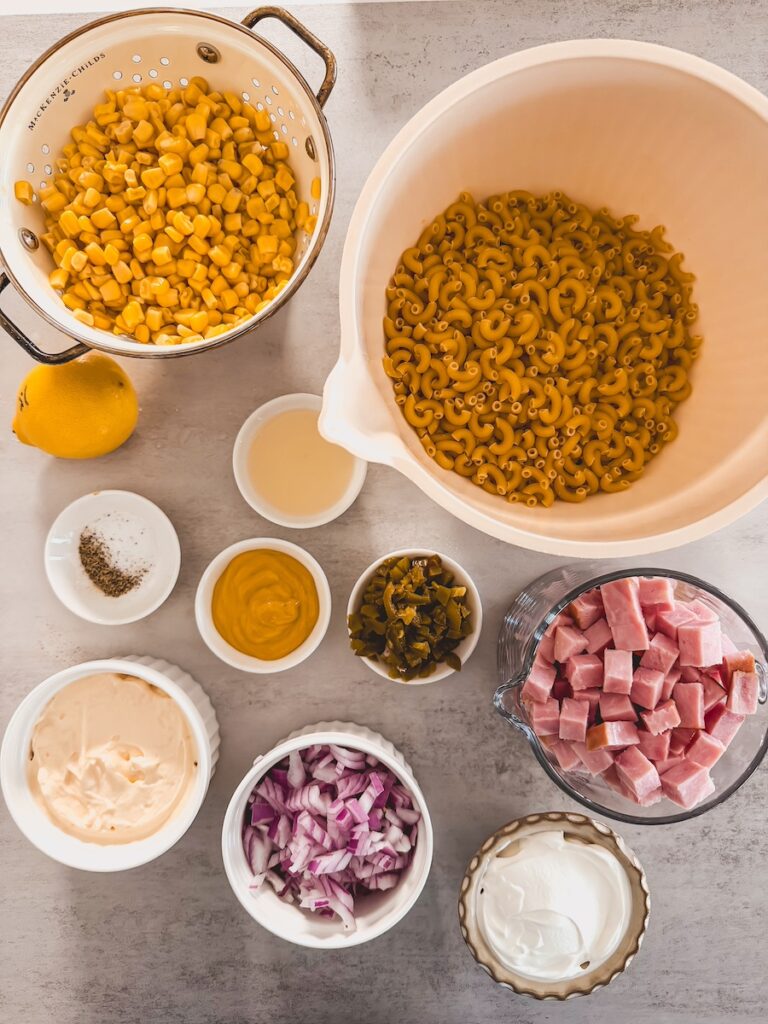 ham pasta salad ingredients in bowls on counter