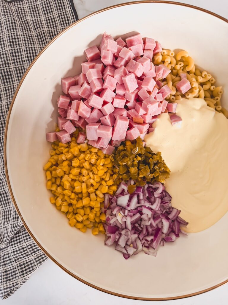 ham pasta salad ingredients in bowl ready to be mixed