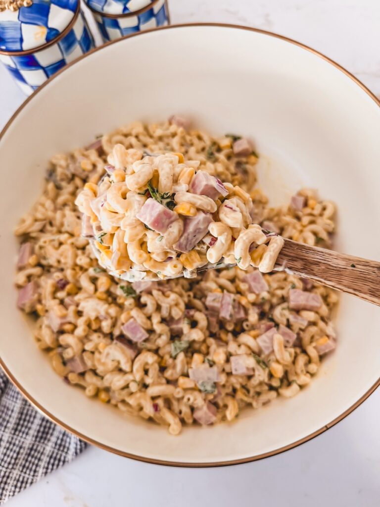 Ham Pasta Salad in serving bowl with spoonful of pasta salad on serving spoon