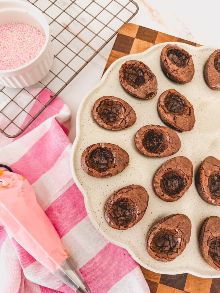 bag of frosting next to tray of brownies