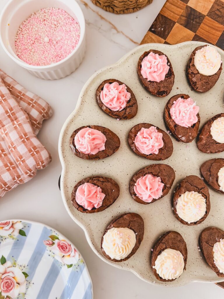 deviled brownies tray with pink and white frosting and sprinkles for easter dessert