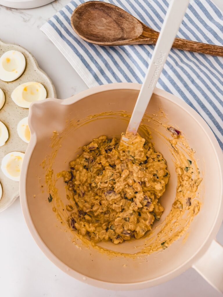 egg filling mixed in white bowl
