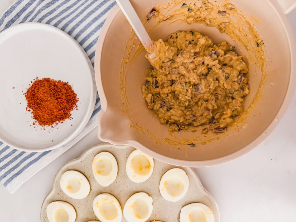 filling in bowl next to tray of eggs
