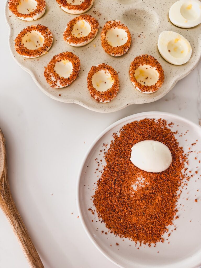 egg face side down on a plate of tajin