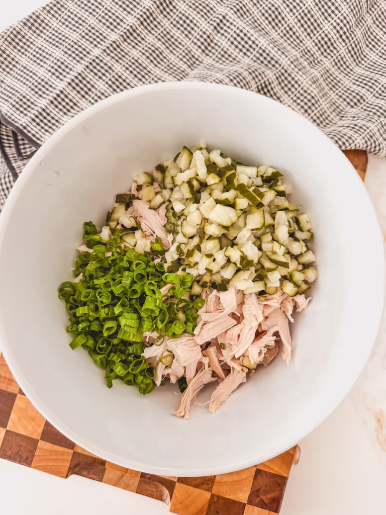chicken, pickles and green onions in bowl