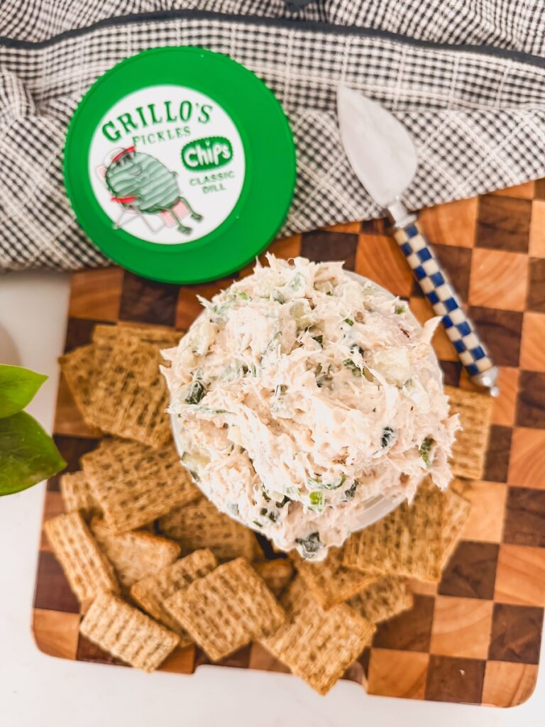 bowl of chicken salad next to triskets