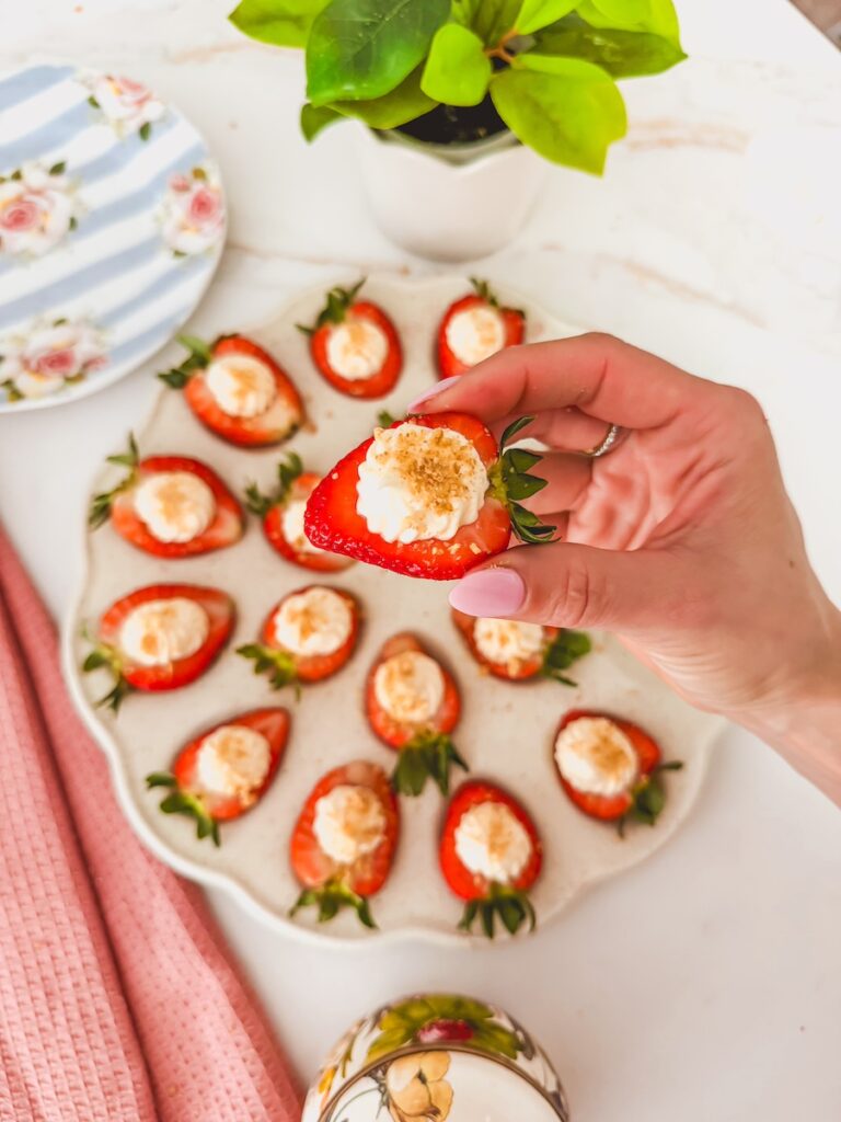 hand holding deviled strawberry