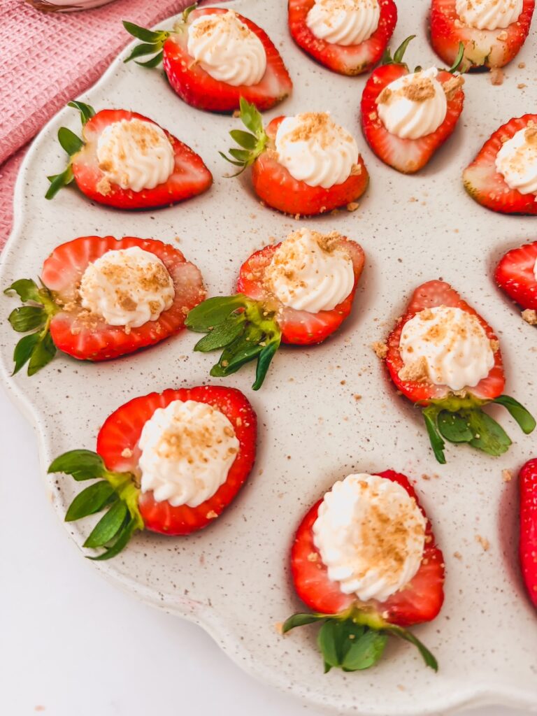 close up of deviled strawberries on tray