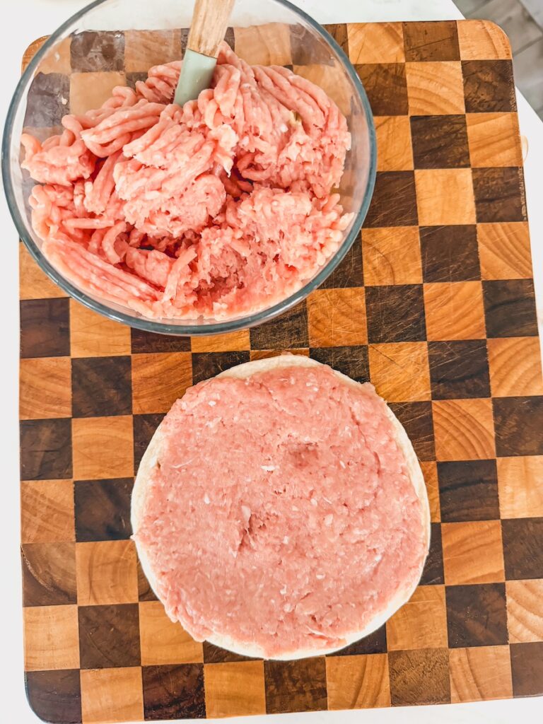ground chicken spread on flour tortilla