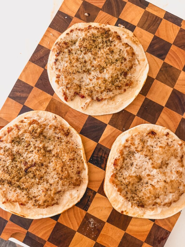 cooked ground chicken on flour tortilla on wood board