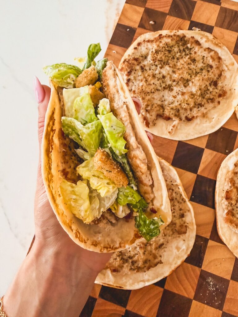 close up of hand holding smash taco