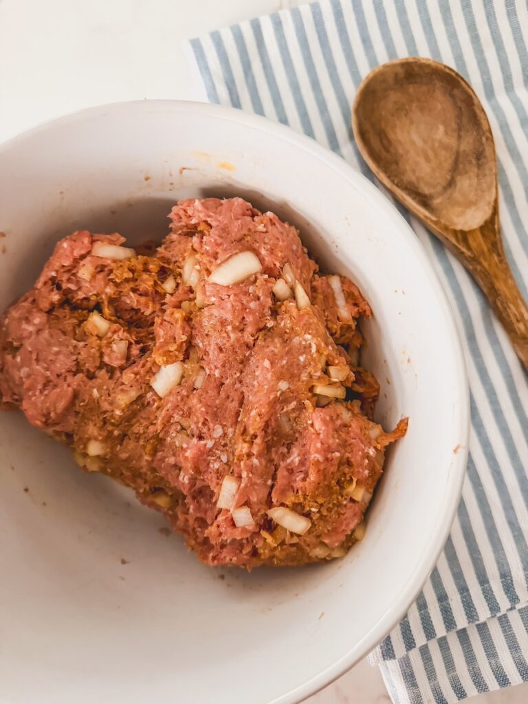 meat mixture combined in white bowl