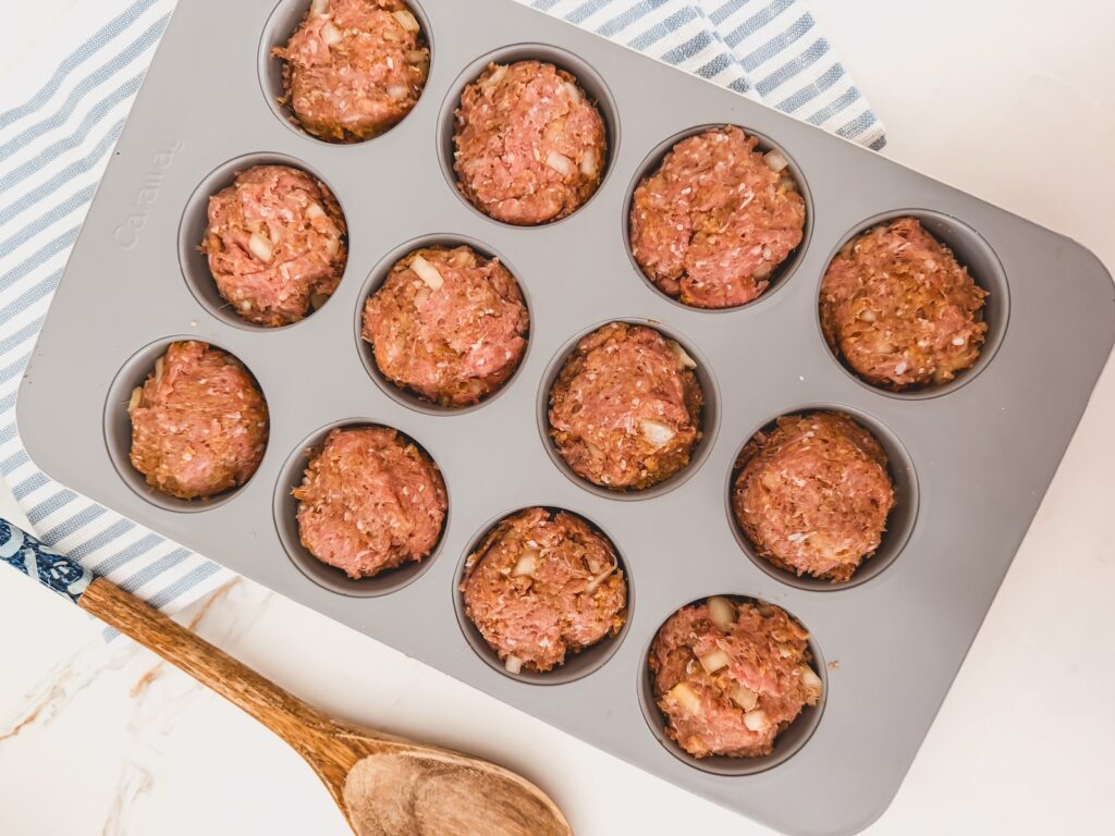 meat mixture in muffin tin